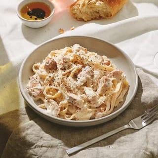 Chicken Fettuccine Alfredo (Grilled Chicken, Fettuccine, Alfredo sauce topped with fresh Parmesan cheese)